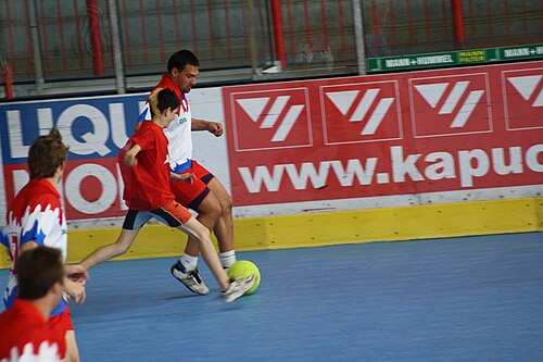 Jogadores disputam bola em partida de futsal
