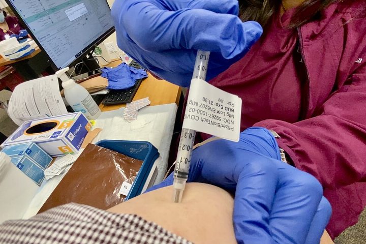 2019 novel coronavirus disease — COVID-19 —vaccination injection into an arm on March 18,