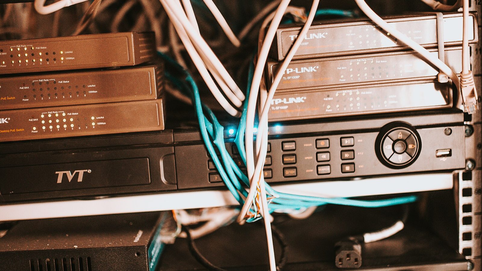 Network equipment and cables organized in a server rack at a modern office environment during the afternoon