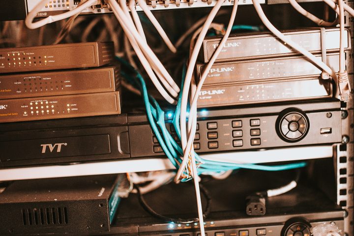 Network equipment and cables organized in a server rack at a modern office environment during the afternoon