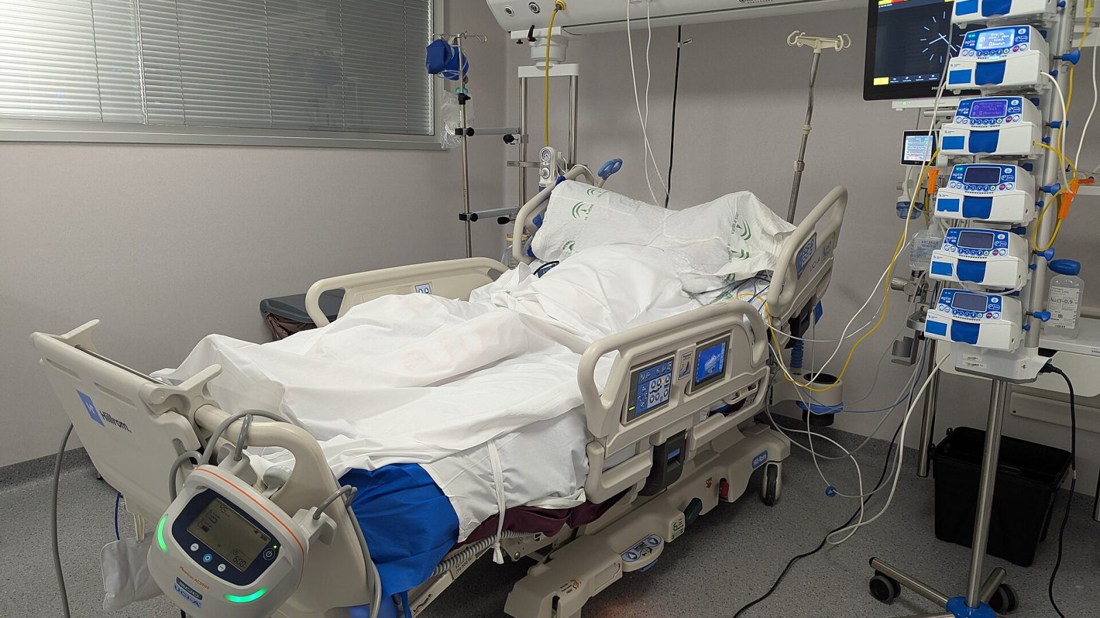 Leito de unidade de terapia intensiva com monitores e equipamentos