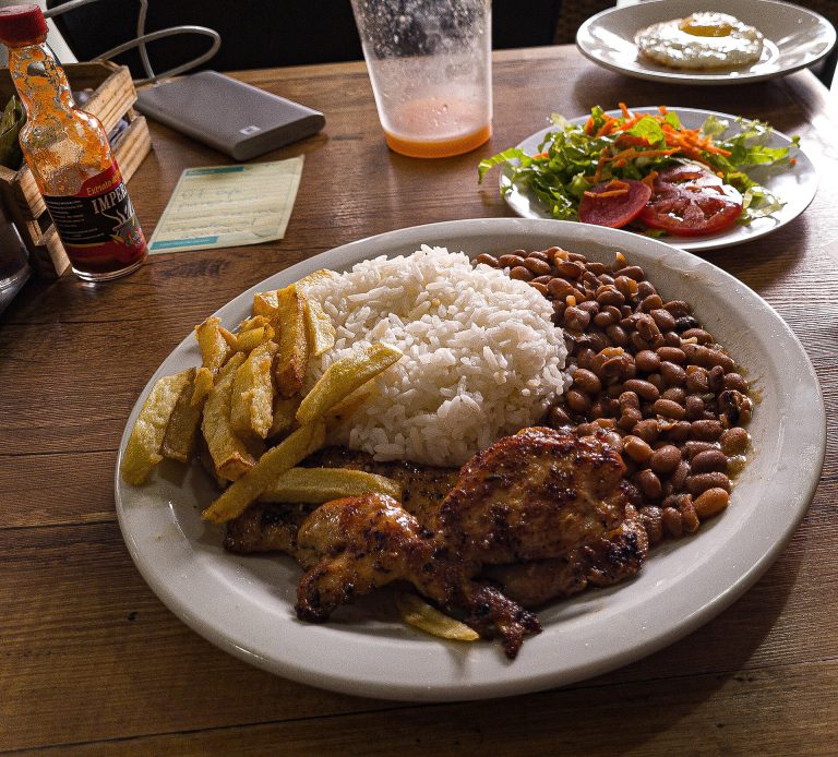 Prato com arroz, feijão, frango, batata frita e salada